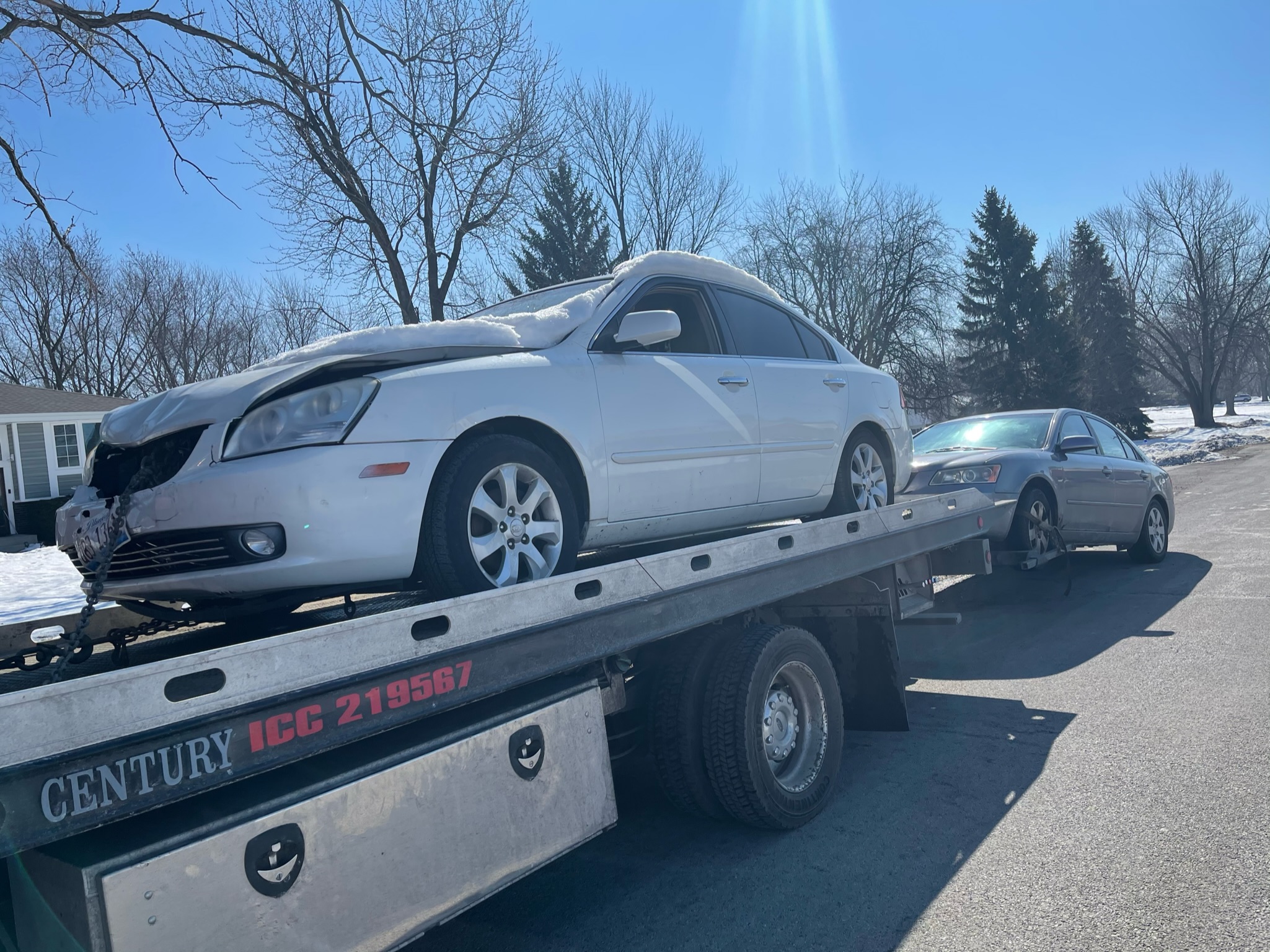 a-tow-truck-with-a-car-on-the-back-of-it.