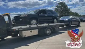 A junk car pulled by a tow truck, sell junk cars with A+ Cash For Junk Cars.