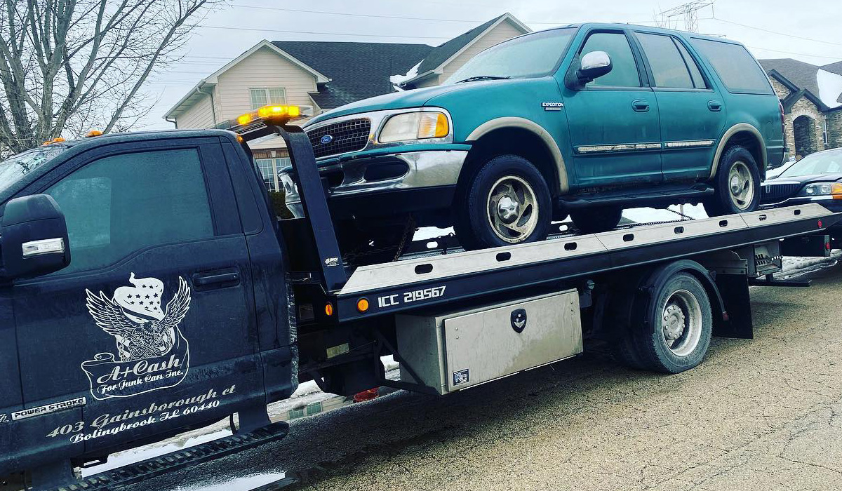 a towing truck removing junk cars