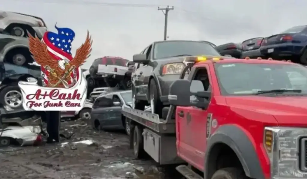 Tow truck from A+ Cash For Junk Cars loading a vehicle at a junkyard for eco-friendly junk car removal.