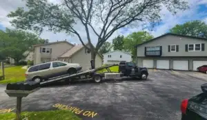 Tow truck loading vehicle, illustrating a hassle-free way to junk your car in local neighborhoods.