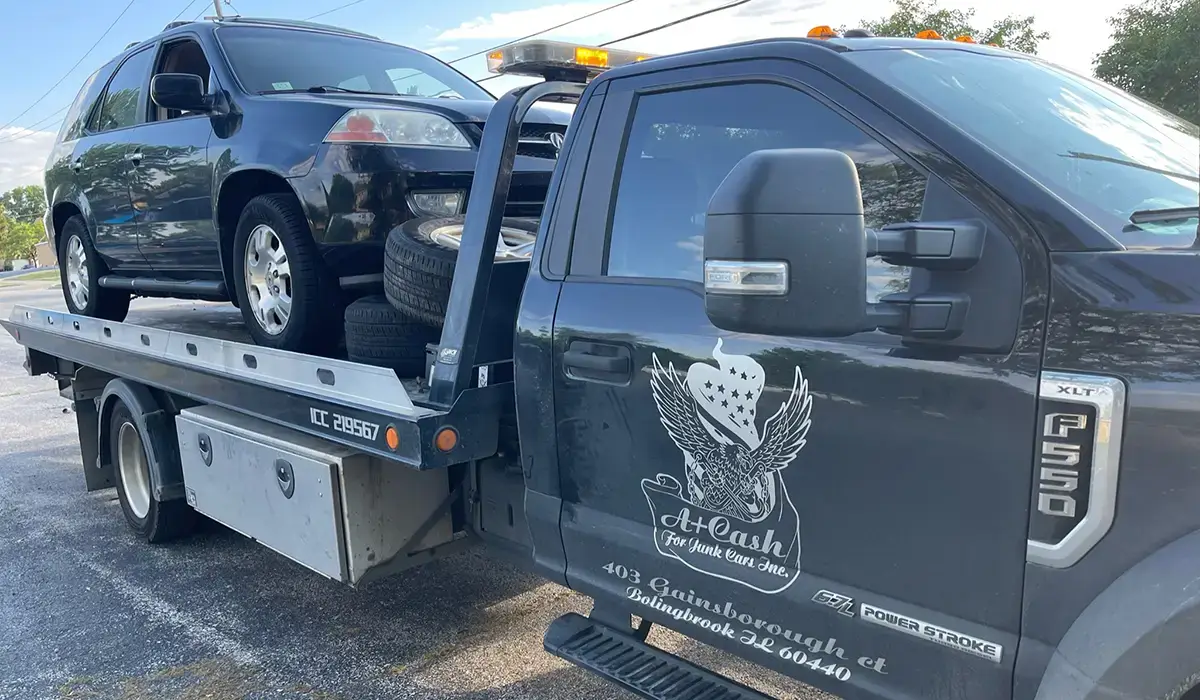 Flatbed tow truck loaded with a junk car, highlighting services to sell your junk car for cash hassle-free.