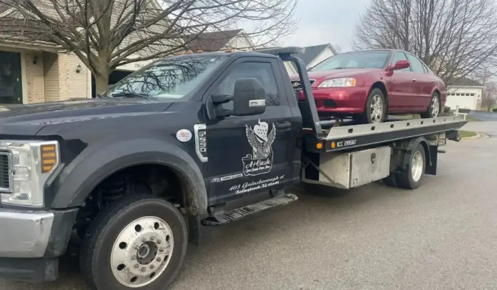 Tow truck from A+ Cash For Junk Cars removing unwanted vehicle from residential estate in Bolingbrook, IL.